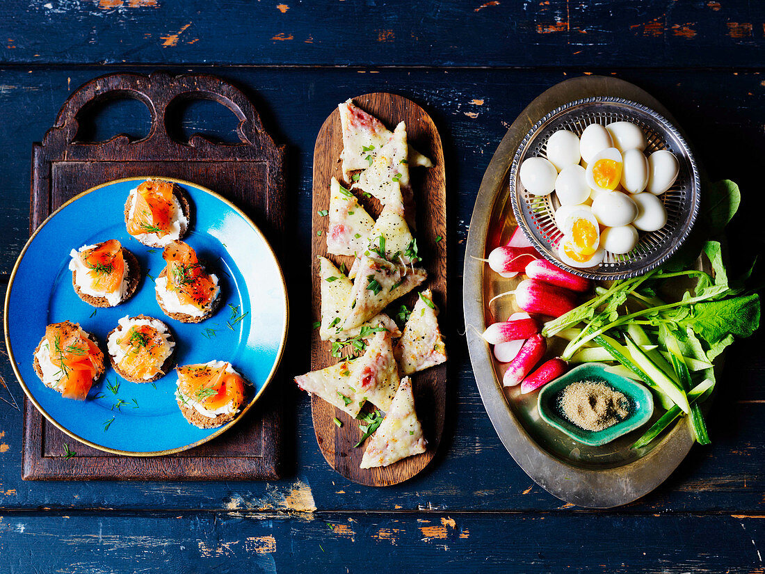 Quail eggs, radish, cucumber, toast with cheese, canape with smoked salmon