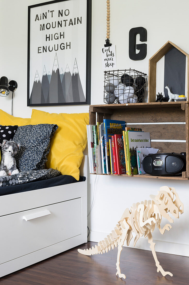 Wooden crate used as bedside cabinet next to bed in boy's bedroom