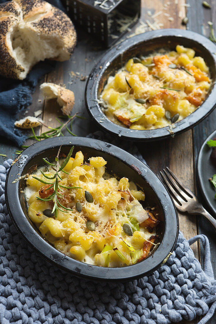 Individual dishes of Mac and cheese with butternut squash and sage