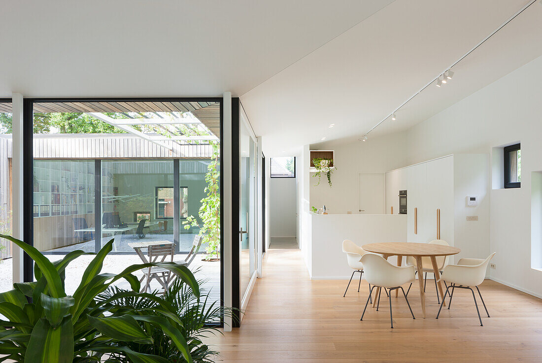 Open-plan living area with modern dining area and view of the terrace