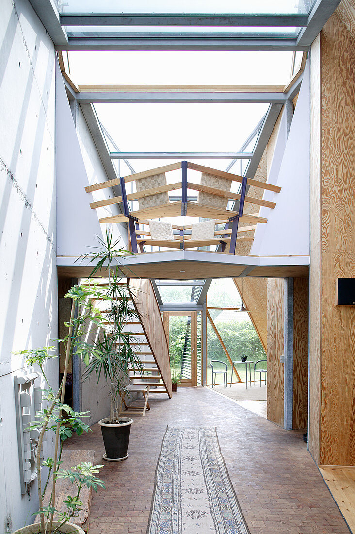 Offener Wohnraum mit Holztreppe im Architektenhaus