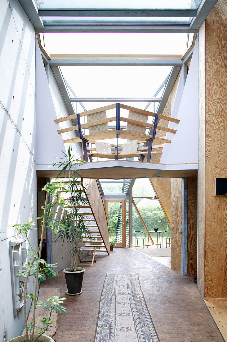 Wooden staircase in open-plan interior of architect-designed house