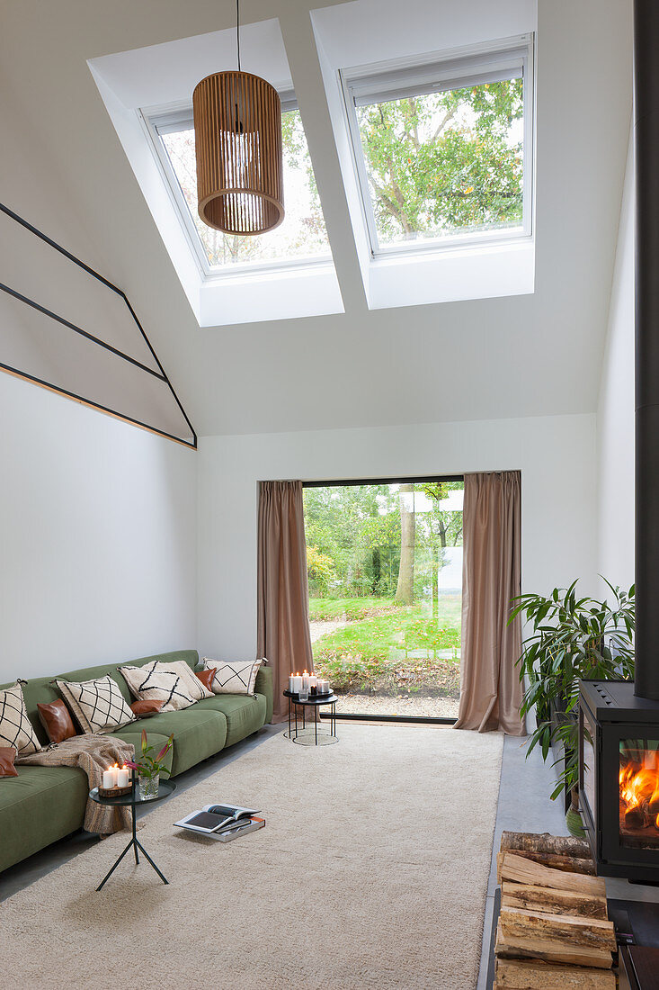 Modern, double-height living room with skylights