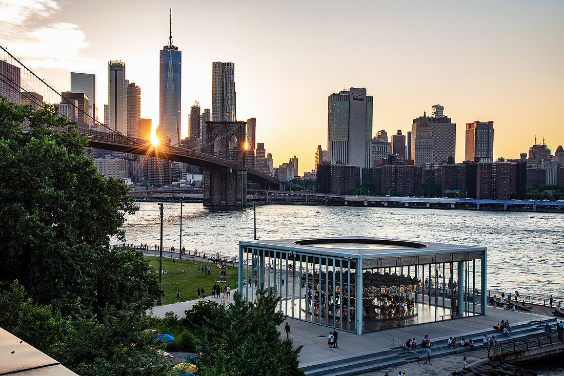 A view of Brooklyn Bridge with Jane's Carousel in the foreground, New York City, USA