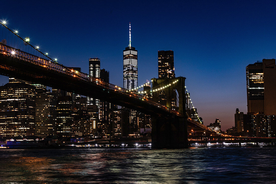 A view of Brooklyn Bridge lit up in the evening, New York City, USA