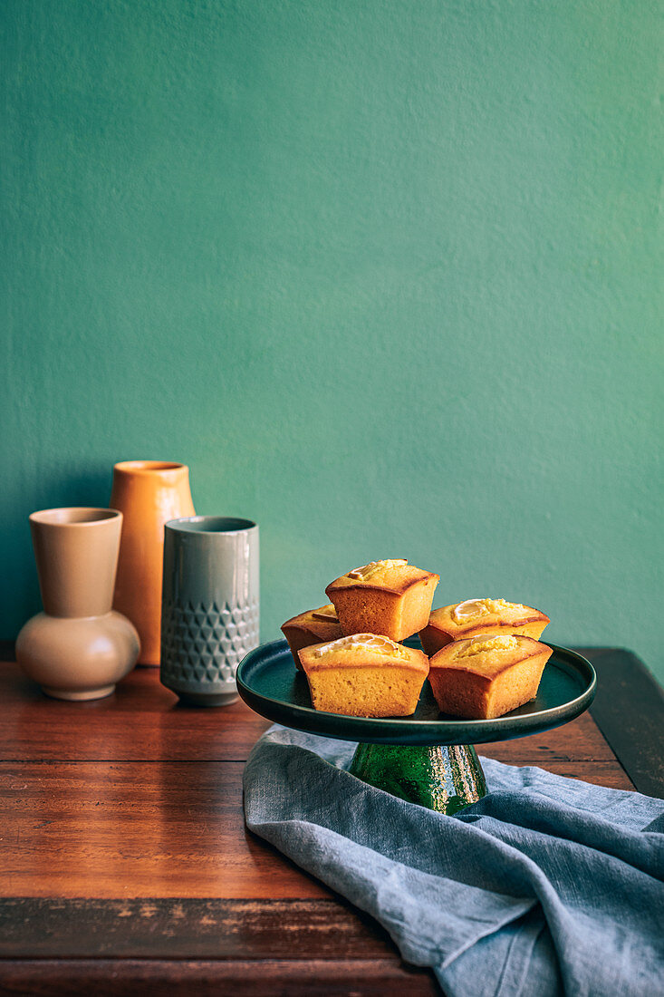 Lemon Turmeric Cakes on green cakestand and table
