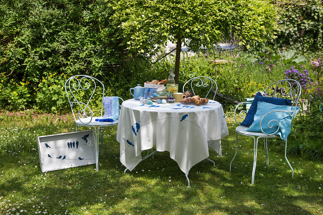 Table set for Easter breakfast in garden