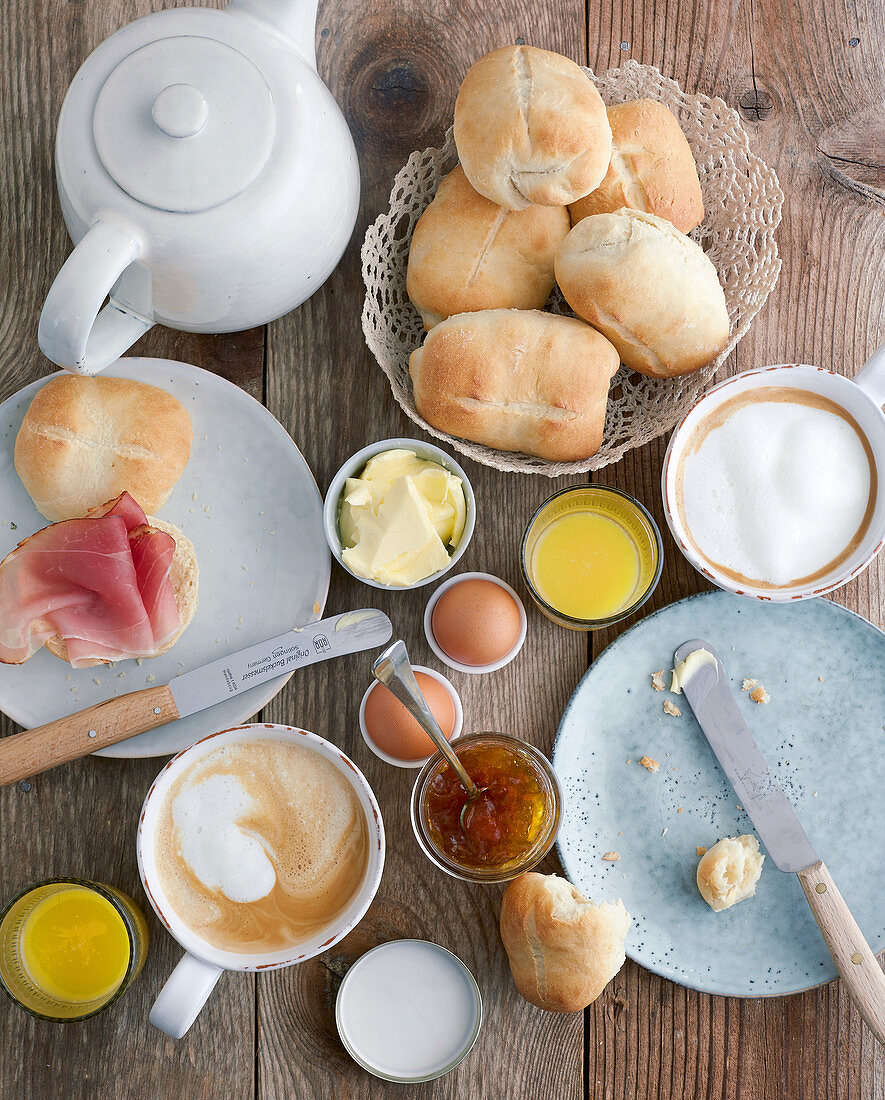 Homemade breakfast rolls on a table laid for breakfast