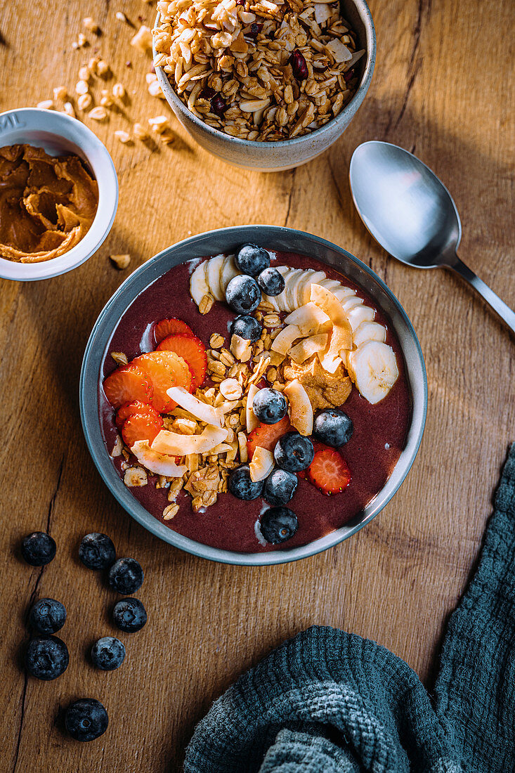 Vegane Acai-Bowl mit Kokoschips und frischen Früchten