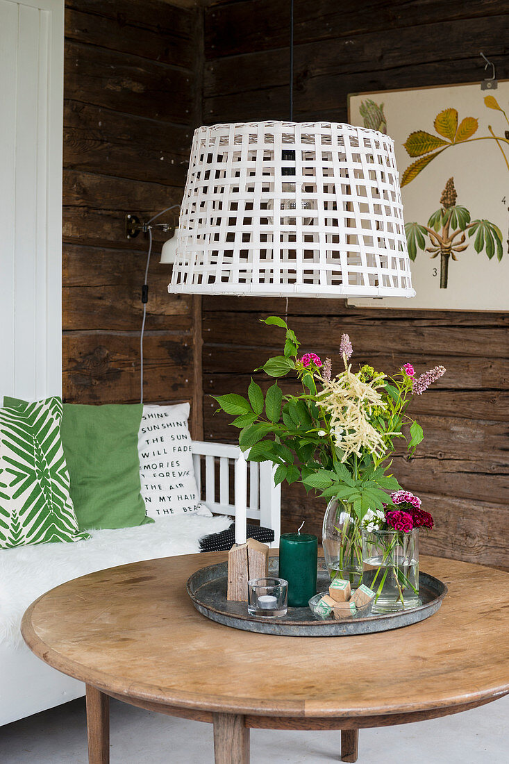 Basket used as pendant lampshade above coffee table in living room