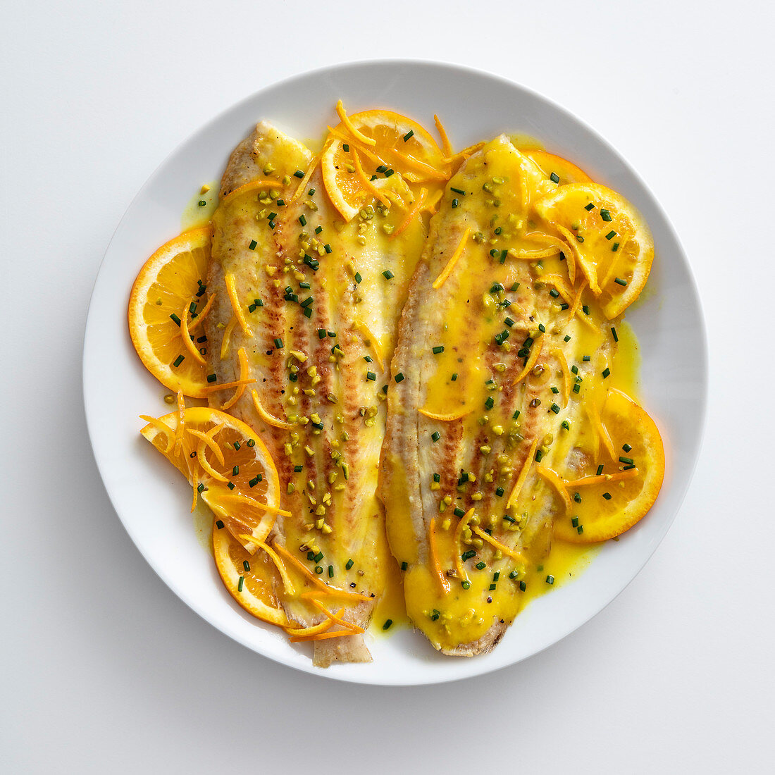 Sole fillets in saffron orange sauce with pistachios
