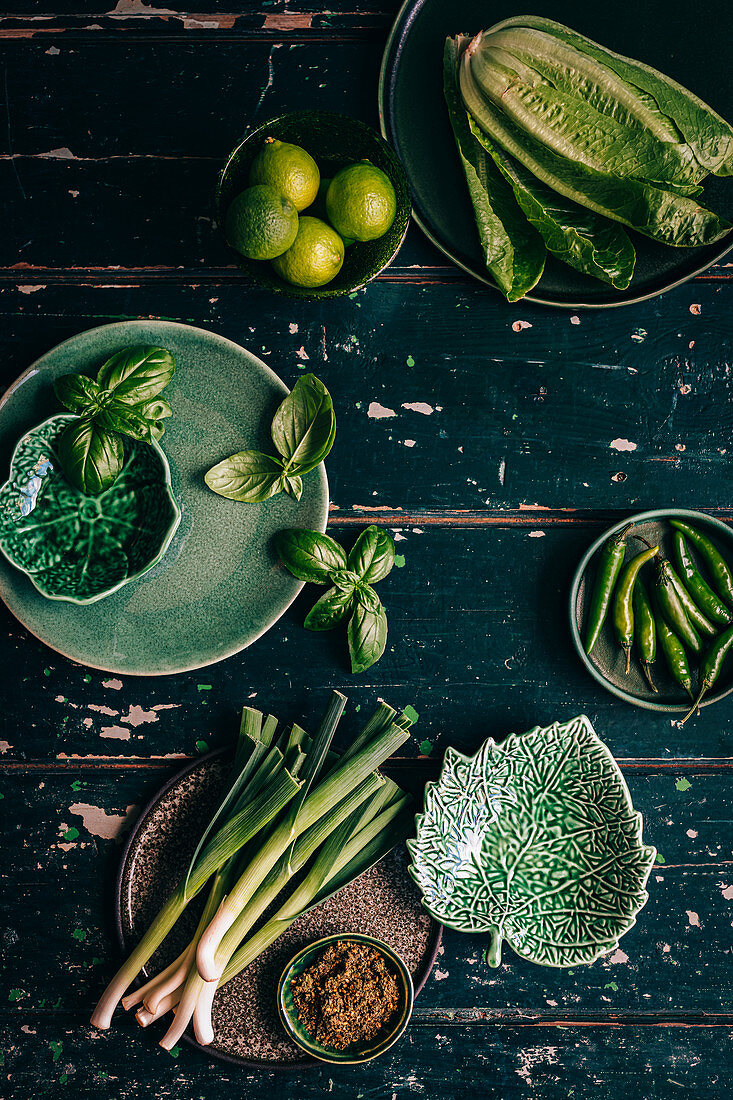 Green Veggies on textured green wooden surface