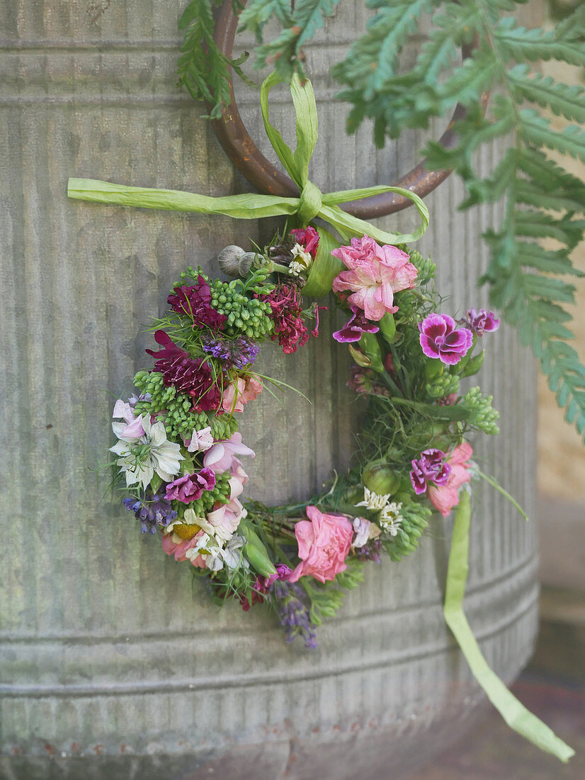 Small wreath of flowers on the zinc bucket