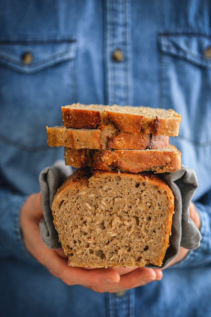 Homemade wheat bread in a man's hands