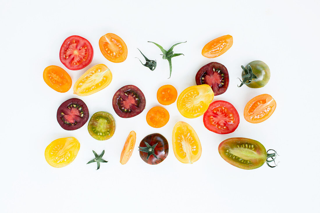 Colourful tomato slices on a white background