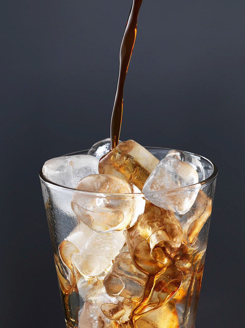 Iced coffee - Pouring coffee on ice cubes