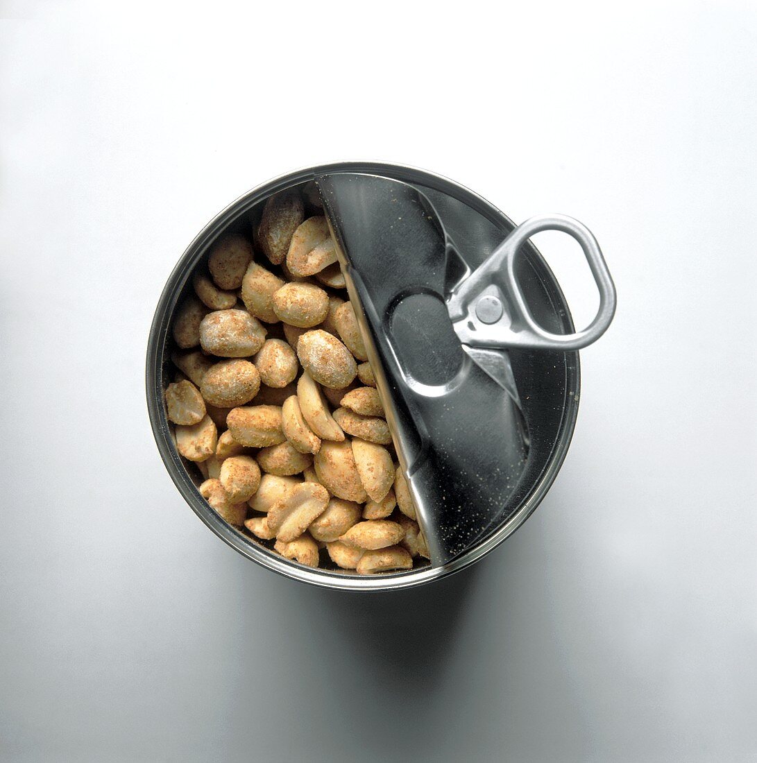 Opened tin of peanuts, from above