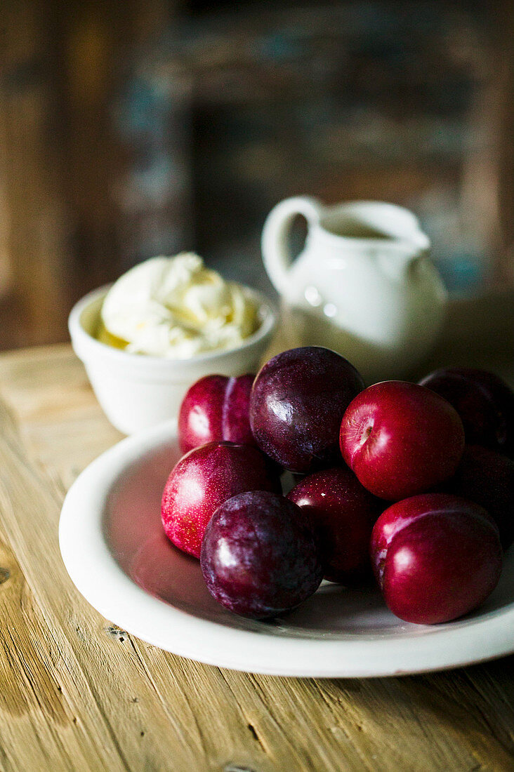 Plums with cream on a table