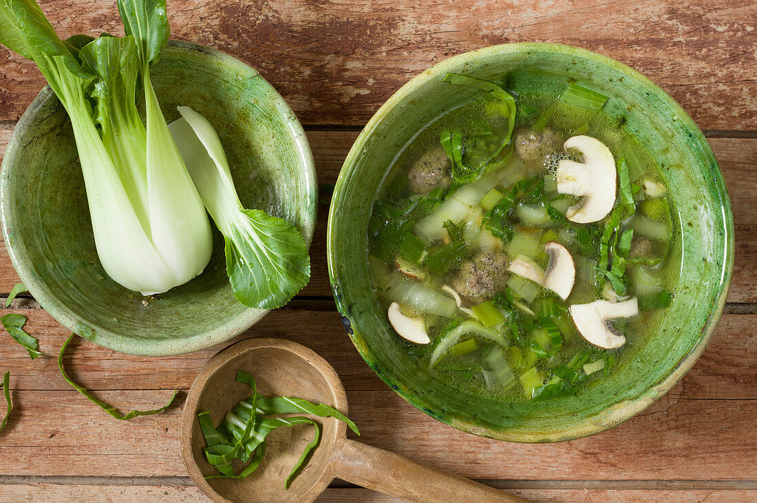 Asian vegetable soup with pak choi, spring onions, mushrooms and ground beef balls