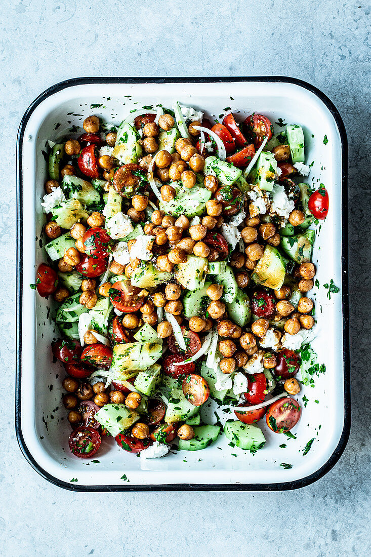 Chickpea salad with feta cheese, cucumber and tomatoes