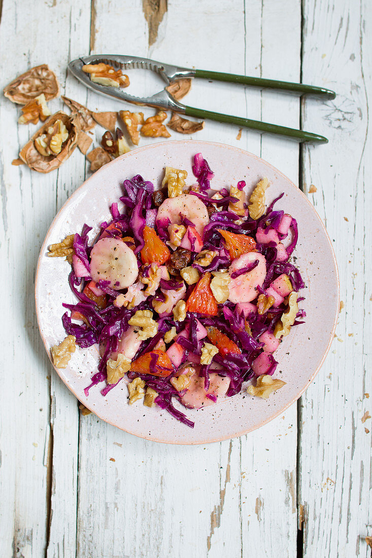 Red cabbage salad with fruits and walnuts