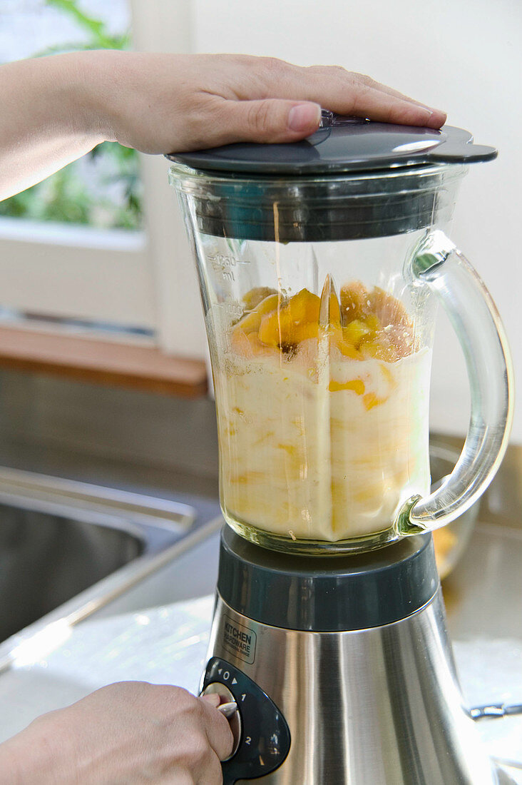 Mango smoothie making in blender