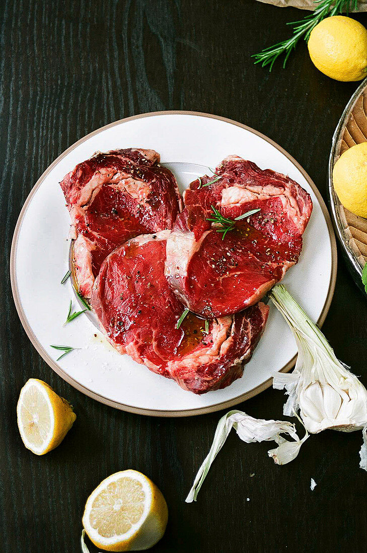 Marinating steaks with rosemary and garlic