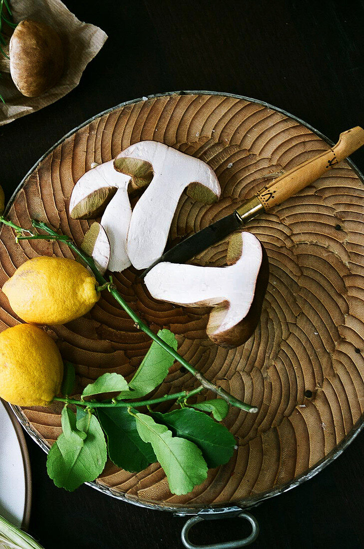Mushroom and lemons on chopping board