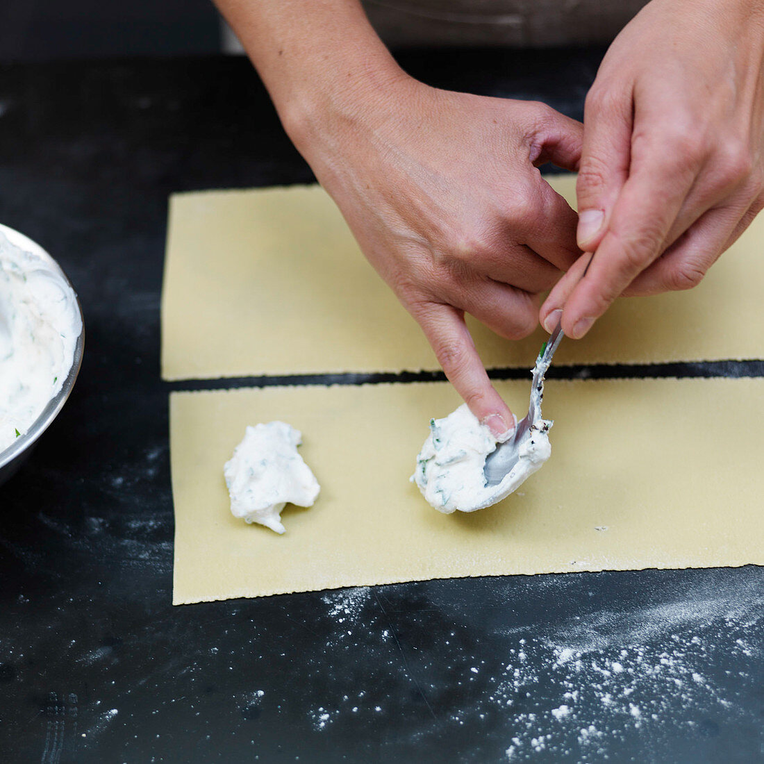 Preparing stuffed pasta: place the filling on the dough sheet