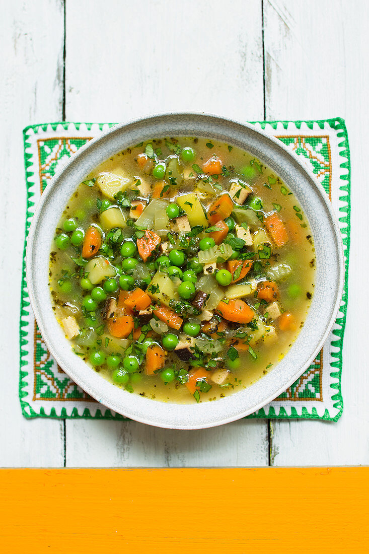 Vegan vegetable soup with peas and smoked tofu