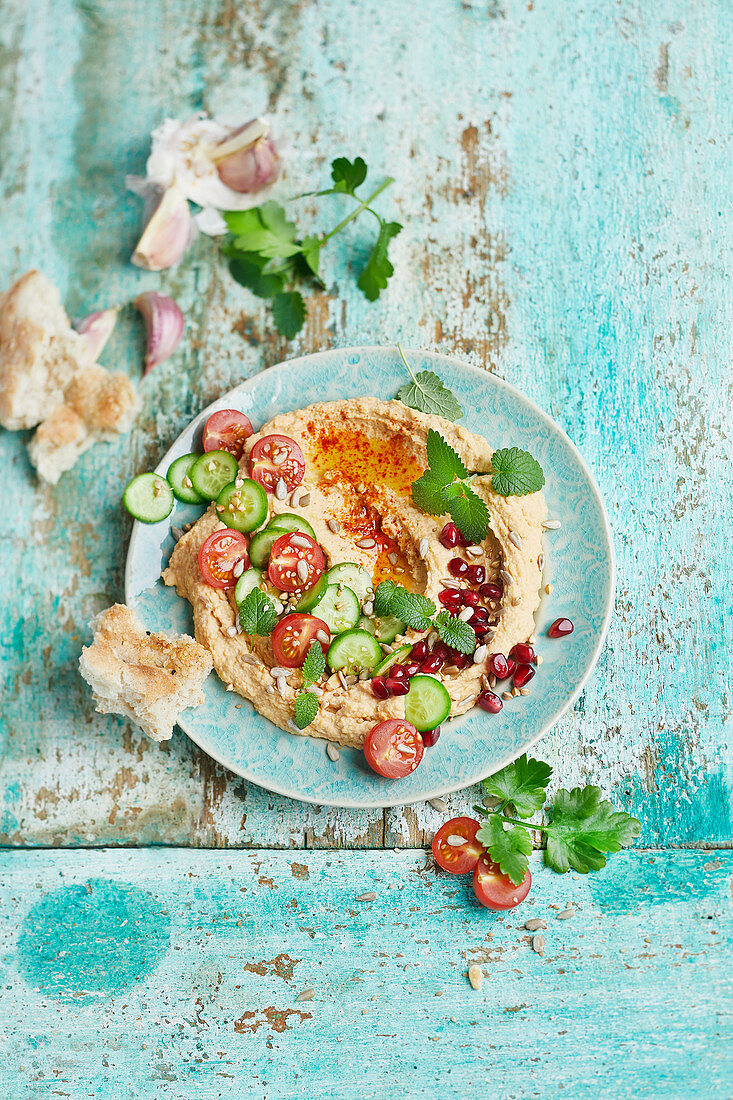 Hummus with tomatoes, cucumber and pomegranate