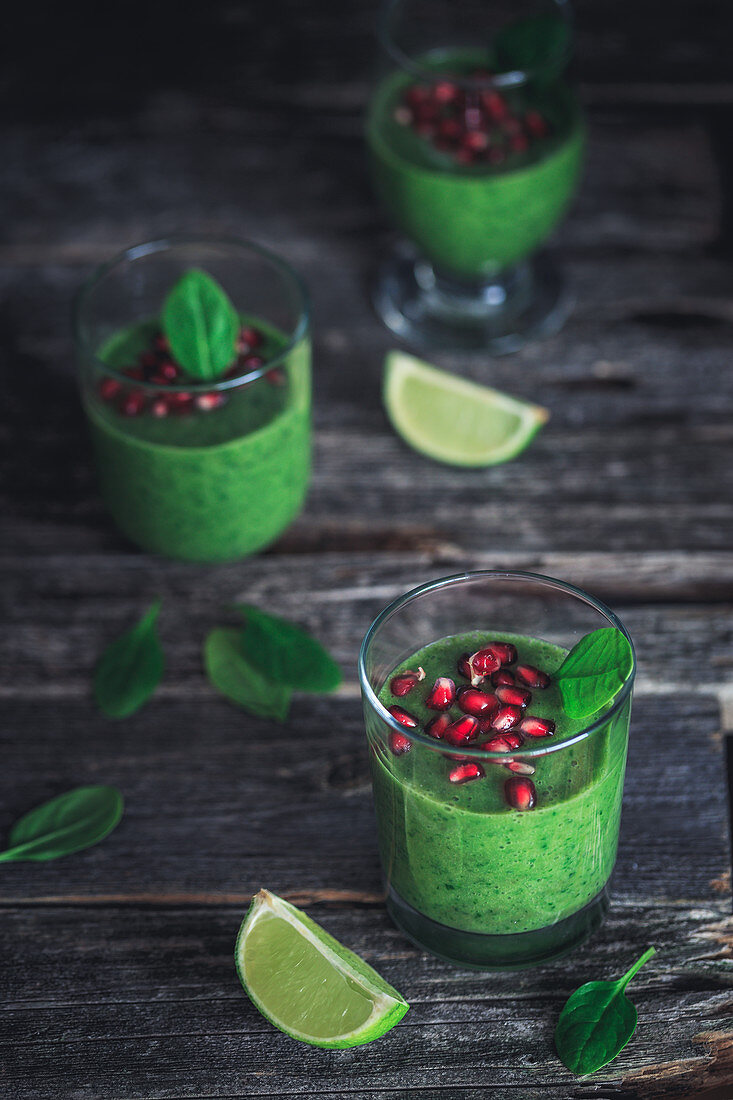 Green spinach smoothie with pomegranate seeds