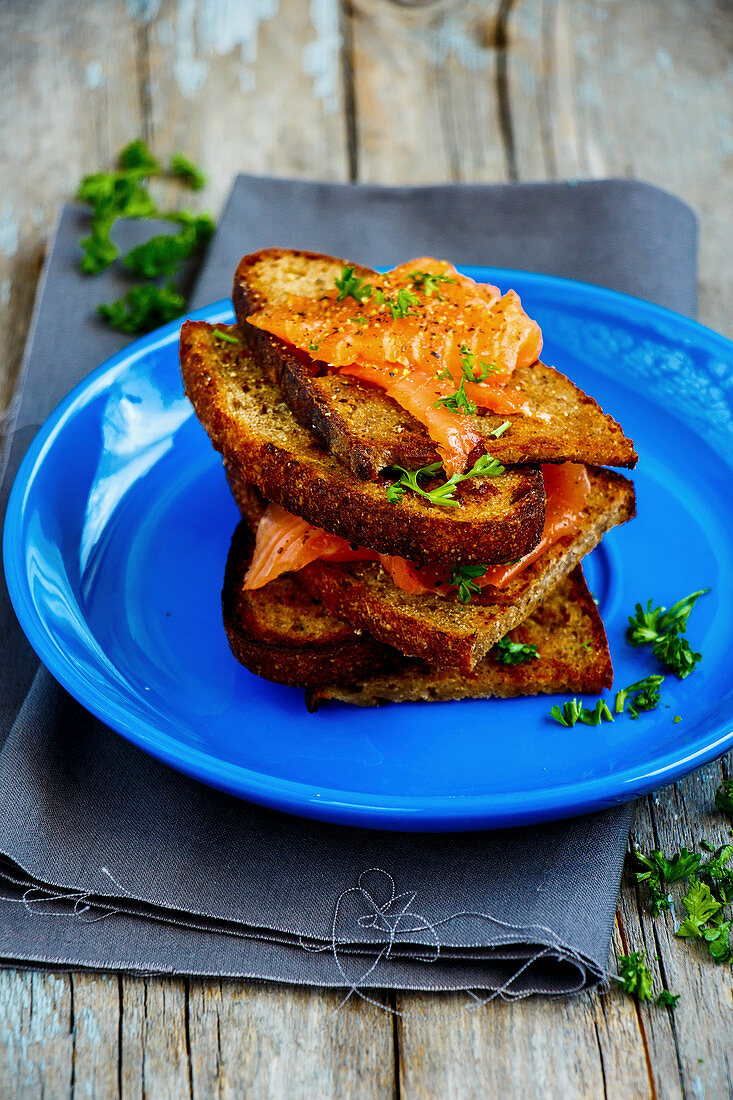 Grilled bread with salmon and herbs