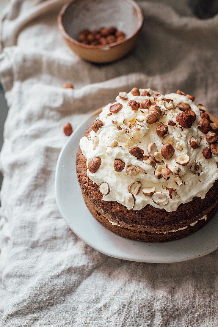 Carrot cake with cream frosting and hazelnuts