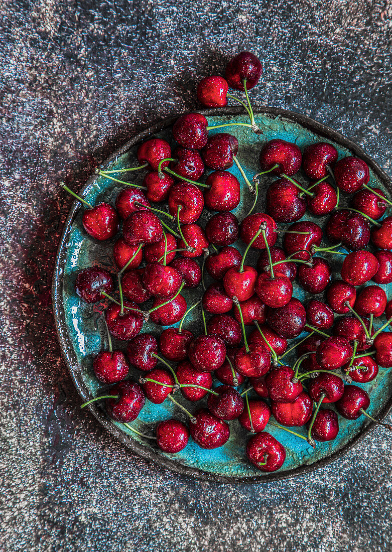 Cherries on green plate