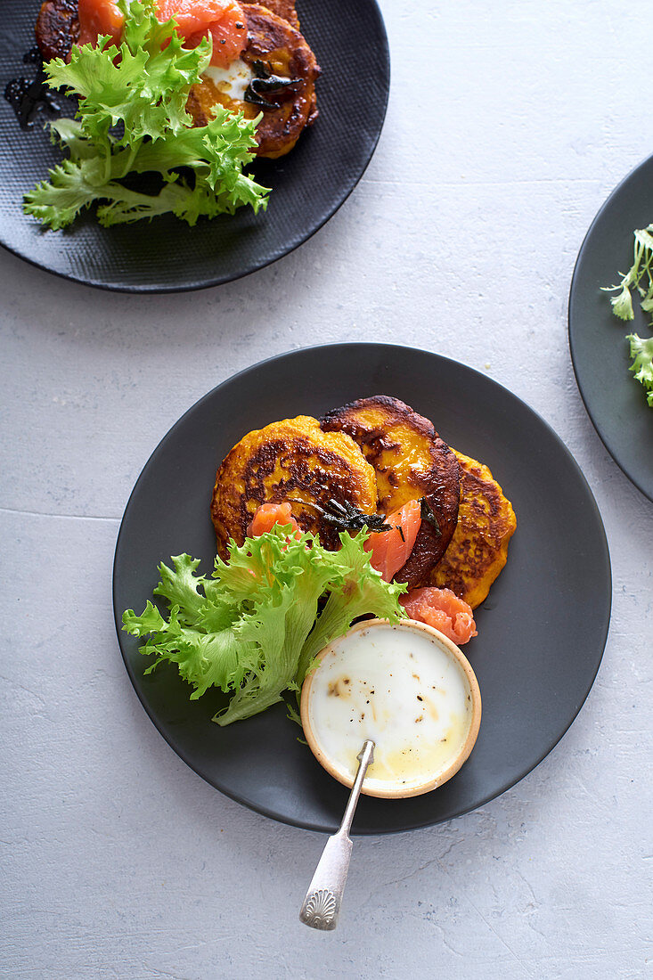 Lunch flatlay with pumpkin fritters with smoked salmon and salad