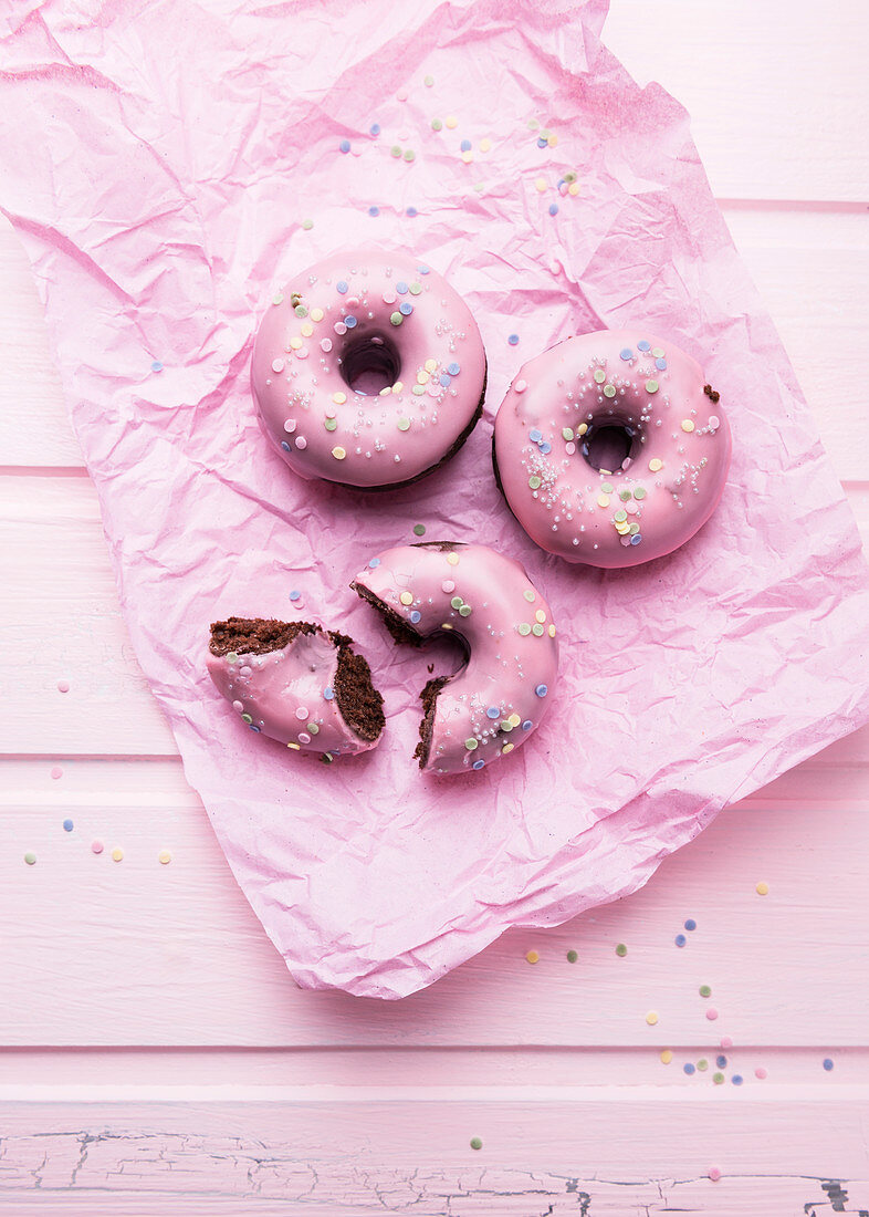 Vegan chocolate donuts with icing and sugar decorations