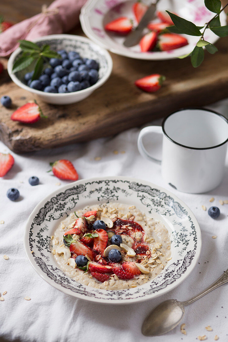 Breakfast table with porridge and fresh fruit