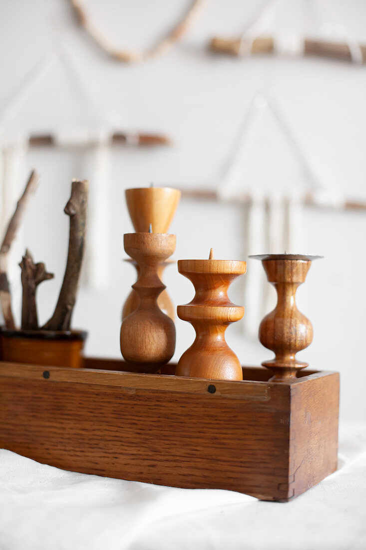 Natural, Bohemian-style arrangement of sticks and wooden candle holders