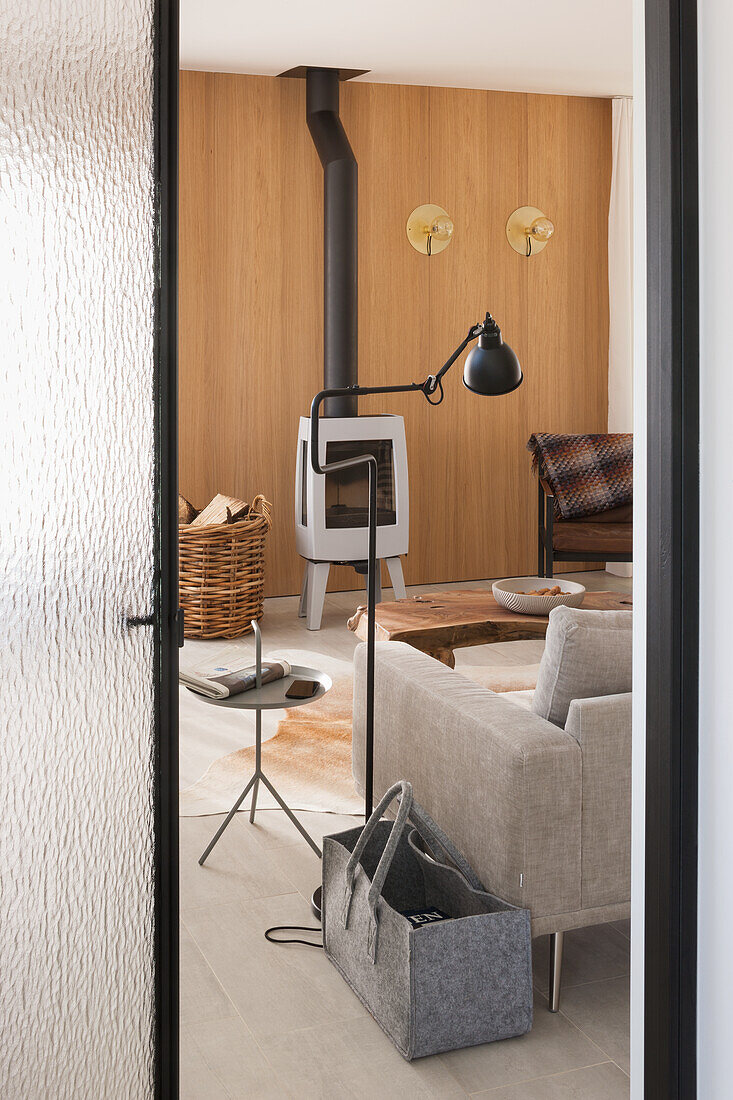 Modern living room with wood-burning stove and natural-colored wooden elements