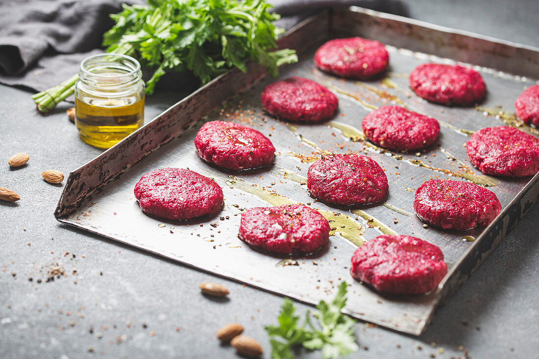 Uncooked red Beetroot burgers on metal tray