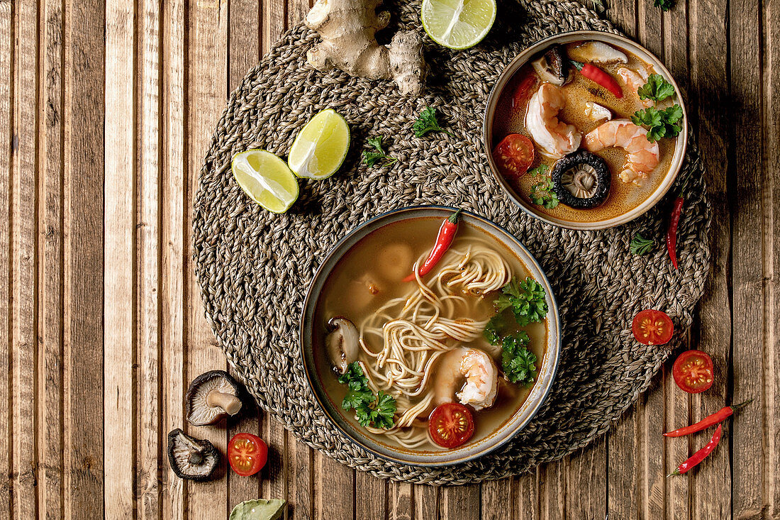 Variety of asian soups. Traditional spicy Thai tom yum kung and noodles soup with shiitake mushrooms, prawns