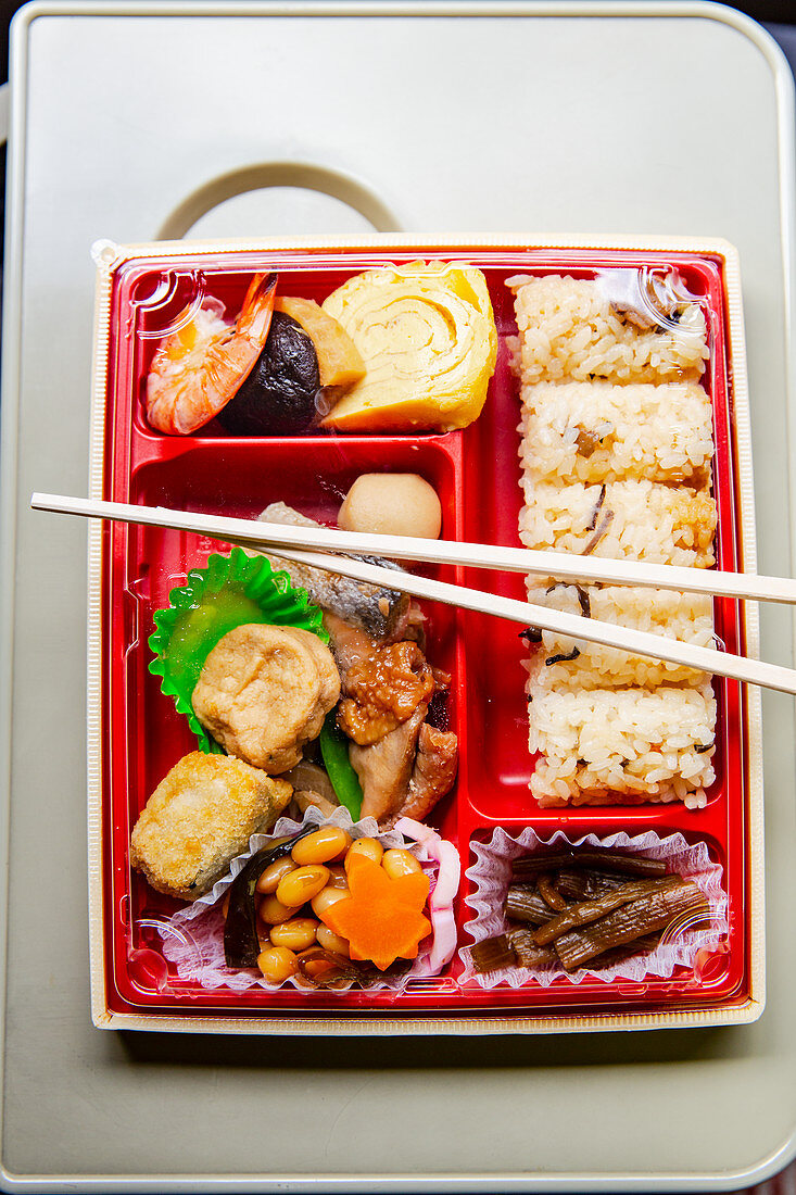 Japanese bento box with rice, omelette, prawn and tofu