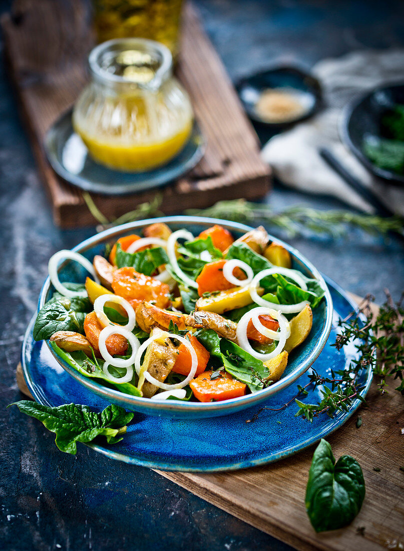 Fresh spinach and roasted potatoes and pumpkin salad