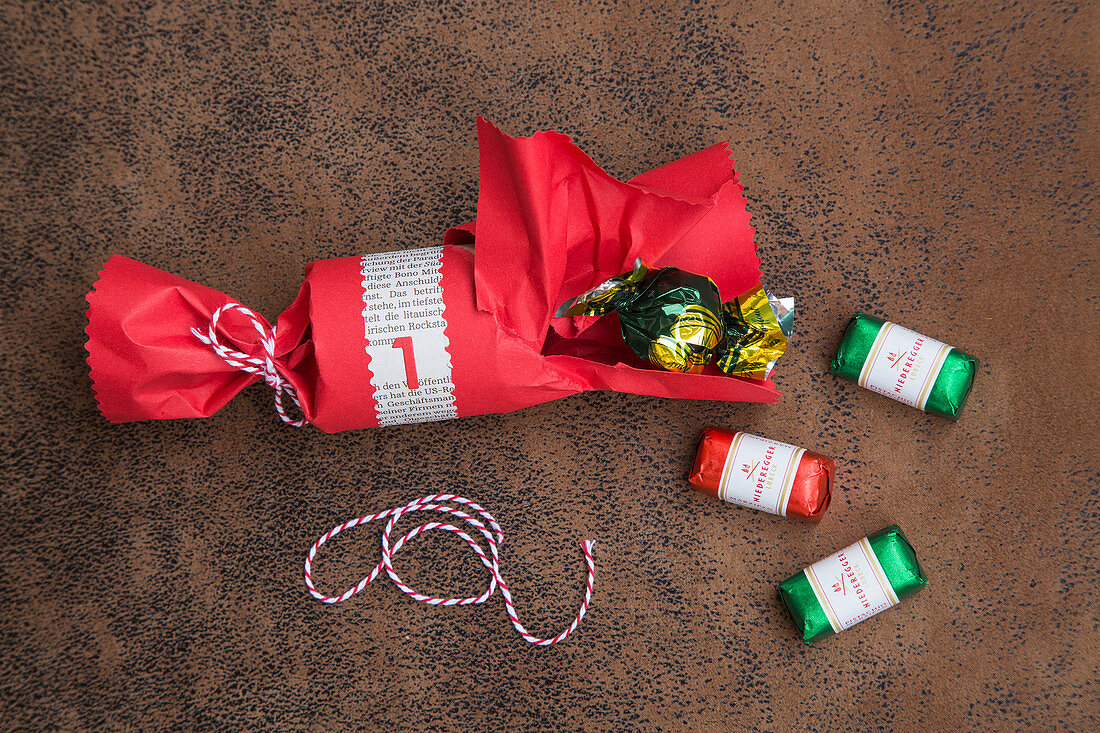 Filling a handmade cracker with sweets for DIY calendar