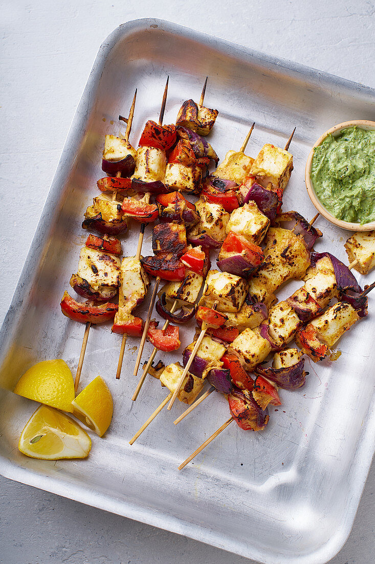 Grilled onion and pepper paneer skewers with peppermint sauce and lemon