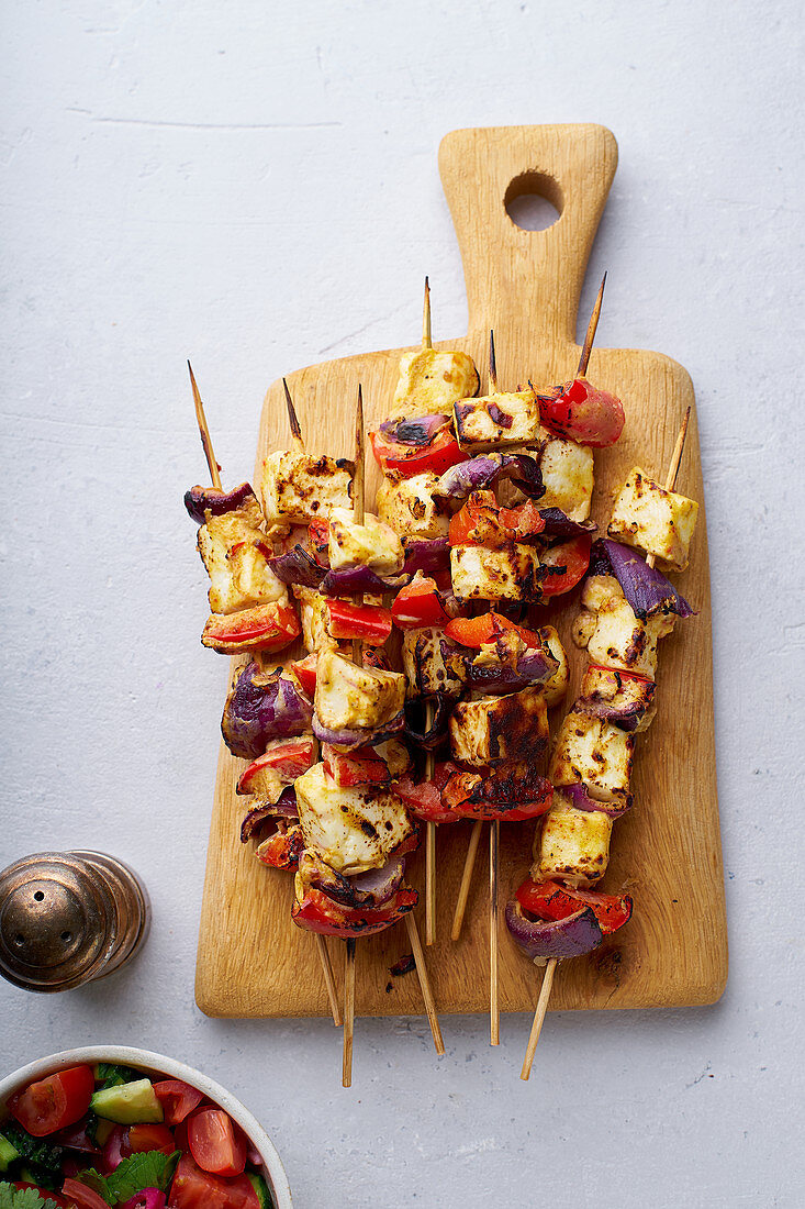 Grilled onion and pepper paneer skewers with tomato and cucumber salad