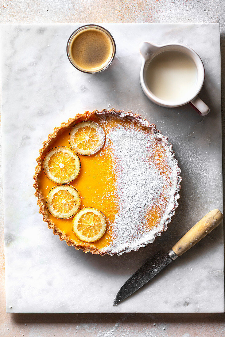 Lemon tart and a cup of coffee on the table