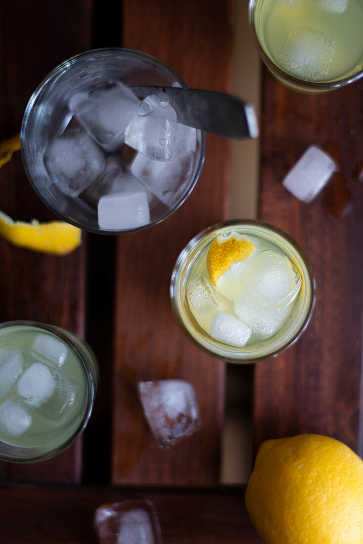 Limoncello with ice cubes and fresh lemon peel