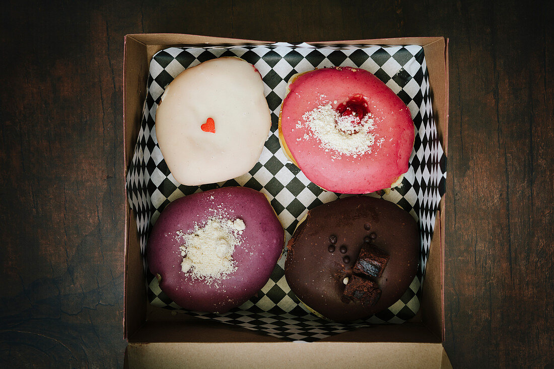 Four gourmet donuts in a box